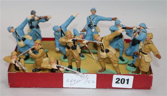 A group of thirteen French composition models of soldiers in WWI uniforms, eight blue, six khaki.